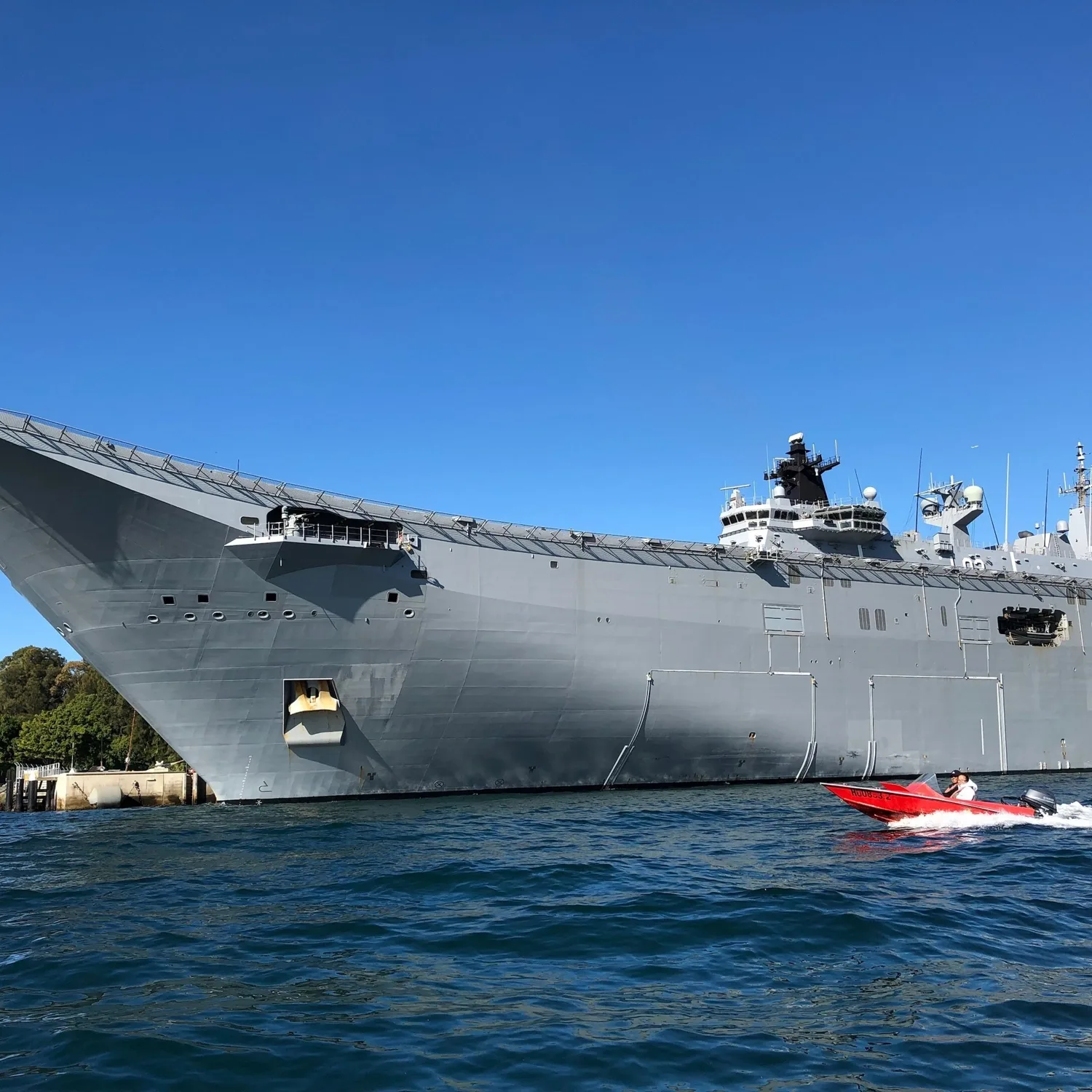 Navy warship at Garden Island with a red speedboat in front