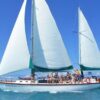 Waltzing Matilda under full sail with guests on deck in the Whitsundays
