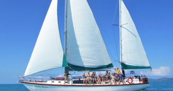 Waltzing Matilda under full sail with guests on deck in the Whitsundays