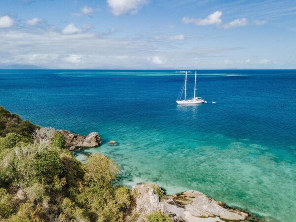 Aerial view of Waltzing Matilda anchored in a turquoise Whitsunday bay