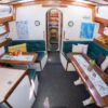 Saloon below deck on Waltzing Matilda with seating and dining tables