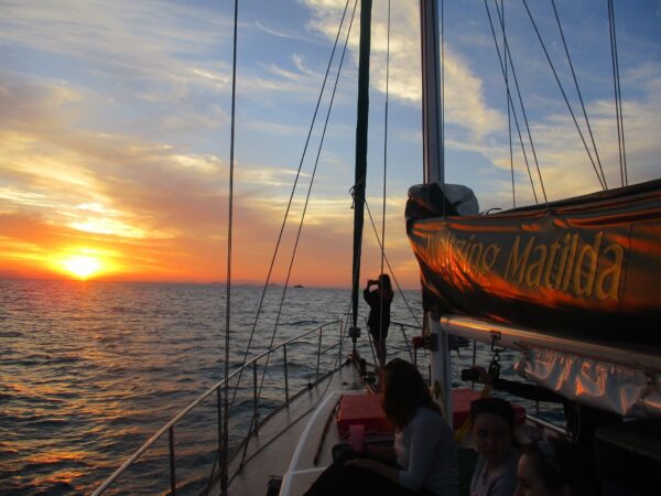 Guests on deck watching the sunset from Waltzing Matilda
